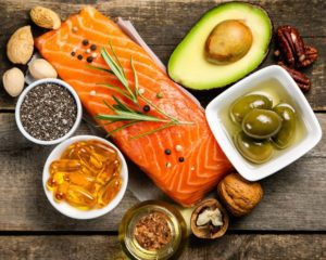 Picture of foods containing omega 3's. Salmon, olives, avocado, walnuts. 
